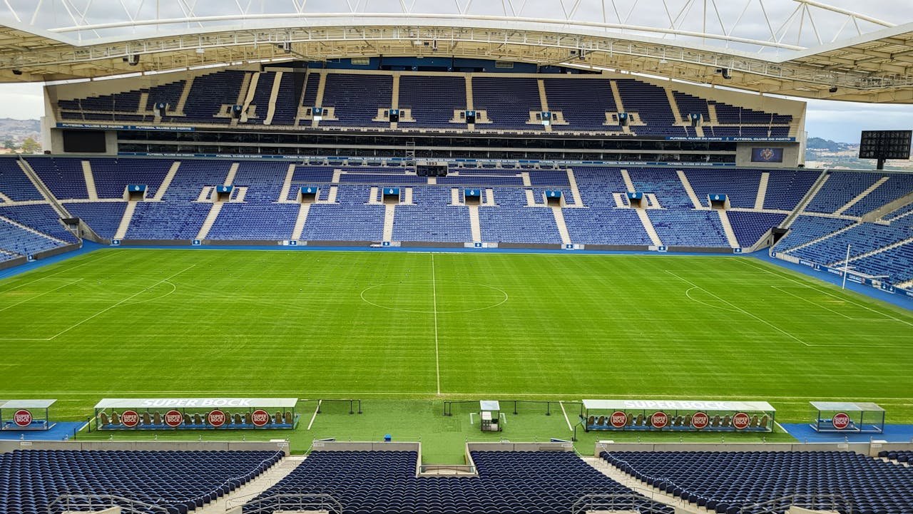 Panoramic view of an empty soccer stadium in Porto, Portugal on a clear day.